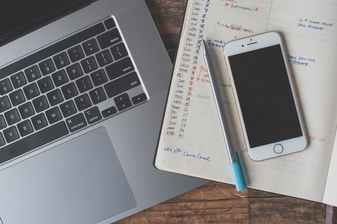 Phone resting on a notebook with a pen, the kind of low-tech check that catches what the AI gets wrong