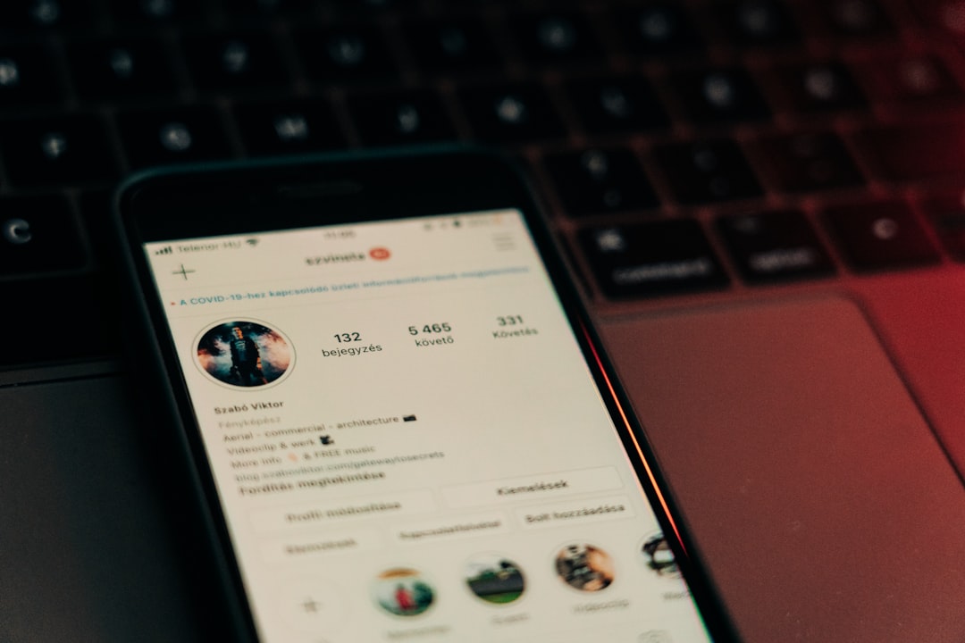 A phone resting on a laptop, the moment between writing the post and scheduling it