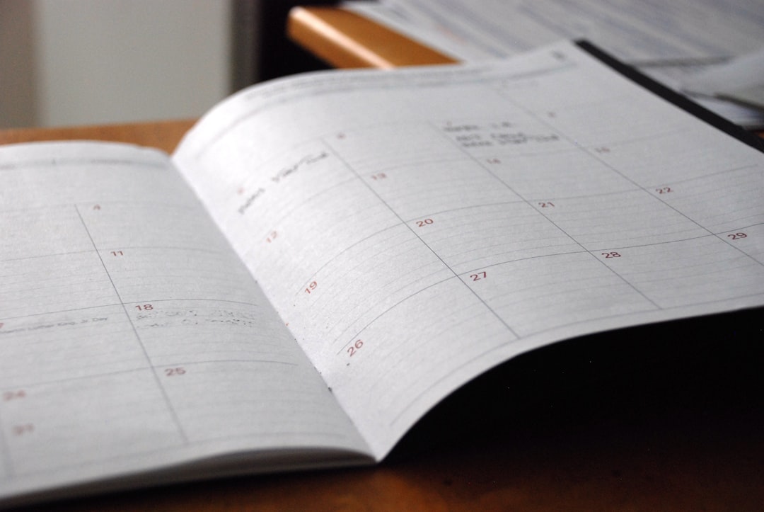 A weekly calendar planner open on a desk